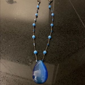 Silver necklace with blue pendant and blue beads